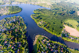 Aerial view of Forest areas on the shores of Lake Ètang de Hirbach with fishing piers in Holving in the state Moselle, France