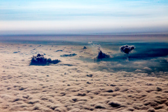 Clouds of smoke of over the power plant of ENBW over clouds-covererd Rhine valley in Karlsruhe in the state Baden-Wurttemberg, Germany