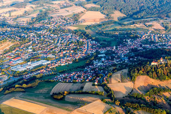 Aerial view of Location view of the streets and houses of residential areas in the valley landscape surrounded by mountains in Reichelsheim (Odenwald) in the state Hesse, Germany