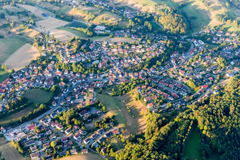 Agricultural land and field borders surround the settlement area of the village in Kirschhausen in the state Hesse, Germany from above