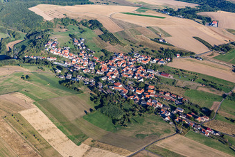 Agricultural land and field borders surround the settlement area of the village in Becherbach bei Meisenheim in the state Rhineland-Palatinate, Germany