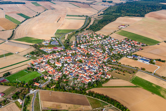 Agricultural land and field borders surround the settlement area of the village in Zeuzleben in the state Bavaria, Germany