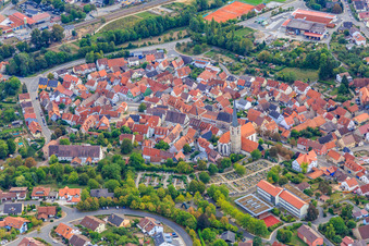Old town center with the Catholic Church of St. Peter and Paul at the cemetery in Grünsfeld in the state Baden-Wuerttemberg, Germany