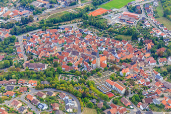 Aerial view of Old town center with the Catholic Church of St. Peter and Paul at the cemetery in Grünsfeld in the state Baden-Wuerttemberg, Germany
