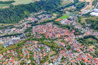 Oblique view of Old town center with the Catholic Church of St. Peter and Paul at the cemetery in Grünsfeld in the state Baden-Wuerttemberg, Germany