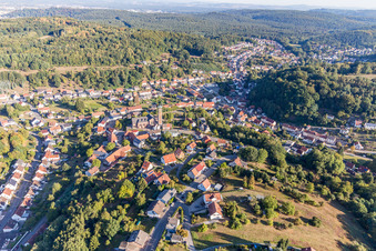 Location view of the streets and houses of residential areas in the valley landscape surrounded by mountains in Kirrberg in the state Saarland, Germany