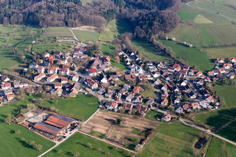 Aerial view of Agricultural land and field borders surround the settlement area of the village in Heuweiler in the state Baden-Wurttemberg, Germany