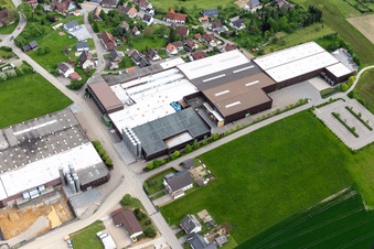 Aerial view of Building and production halls on the premises of Saier Verpackungstechnik in Alpirsbach in the state Baden-Wurttemberg, Germany