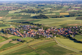 Agricultural land and field borders surround the settlement area of the village in Uhlwiller in Grand Est, France