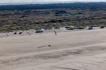 Aerial view of Buggies and kite surfers on the sandy beach in Fanø in the state South Denmark, Denmark