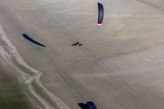 Oblique view of Buggies and kite surfers on the sandy beach in Fanø in the state South Denmark, Denmark