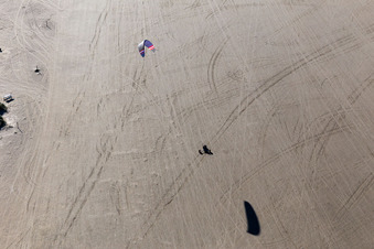Buggies and kite surfers on the sandy beach in Fanø in the state South Denmark, Denmark viewn from the air