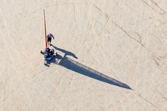 Drone recording of Buggies and kite surfers on the sandy beach in Fanø in the state South Denmark, Denmark