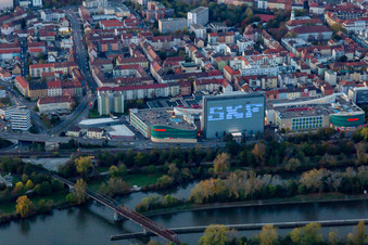 Building of the shopping center Stadtgalerie Schweinfurt and illumated SKF Hochhaus at dusk in Schweinfurt in the state Bavaria, Germany