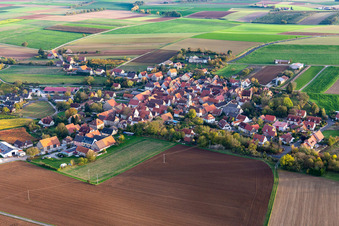 Aerial view of Agricultural land and field borders surround the settlement area of the village in Neuses a.Berg in the state Bavaria, Germany