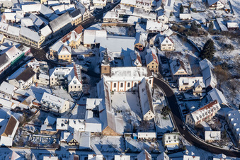 Winter aerial view in the snow of the monastery Klingenmünster in Klingenmünster in the state Rhineland-Palatinate, Germany
