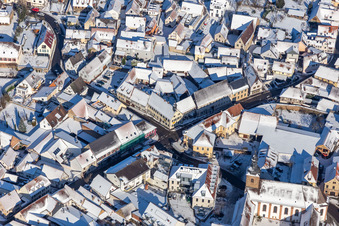 Winter aerial view in the snow of the town center Klingenmünster in Klingenmünster in the state Rhineland-Palatinate, Germany