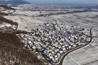 Wintry snowy village - view on the edge of Wine yards below the hilly edge of the Haardt Palatinat forest in Eschbach in the state Rhineland-Palatinate