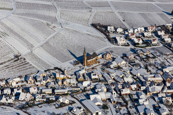 Aerial view of Wintry snowy wine yards surround the settlement area of the village in Birkweiler in the state Rhineland-Palatinate, Germany