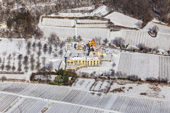 Wintry snowy complex of the hotel building Wohlfuehlhotel Alte Rebschule and Gasthaus Sesel in springtime in Rhodt unter Rietburg in the state Rhineland-Palatinate, Germany