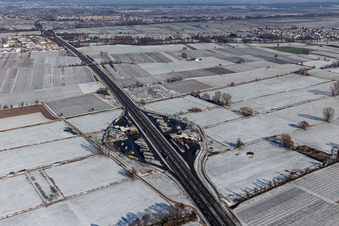 Wintry snowy motorway service area on the edge of the course of BAB highway Serways Pfaelzer Weinstrasse in Edesheim in the state Rhineland-Palatinate