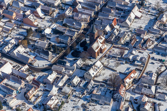 Winter aerial view in the snow of St. Michael Simultankirche in Rohrbach in the state Rhineland-Palatinate, Germany