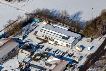 Winter aerial photograph in the snow of car repair shop Peter Thürwächter in Winden in the state Rhineland-Palatinate, Germany