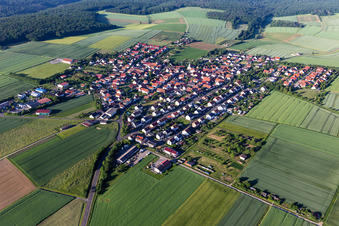 Aerial photograpy of Agricultural land and field boundaries surround the settlement area of the village in Hesselbach in the state Bavaria, Germany