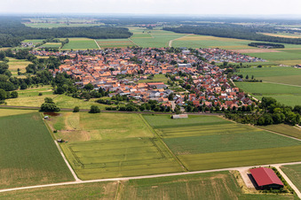Village view on the edge of agricultural fields and land in Steinweiler in the state Rhineland-Palatinate, Germany