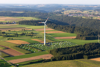 Aerial view of Wind turbine windmills on a solar panel field in Alpirsbach in the state Baden-Wurttemberg, Germany