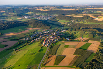 Agricultural land and field boundaries surround the settlement area of the village in Lombach in the state Baden-Wuerttemberg, Germany