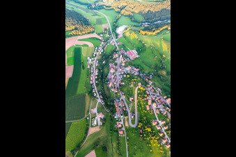 Aerial photograpy of Agricultural land and field boundaries surround the settlement area of the village in Lombach in the state Baden-Wuerttemberg, Germany