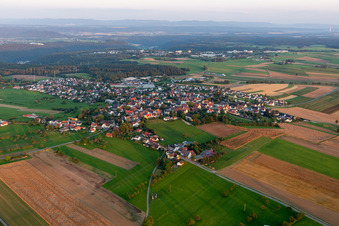 Aerial photograpy of Agricultural land and field borders surround the settlement area of the village in Hochmoessingen in the state Baden-Wurttemberg, Germany