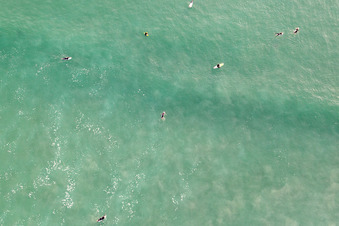 Aerial view of Surfers waiting for the wave in front of the Plage de Tronoën in Saint-Jean-Trolimon in the state Finistere, France
