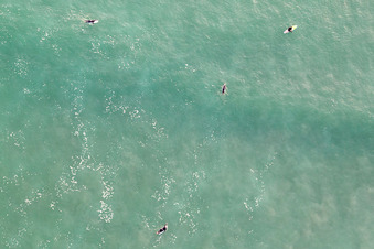 Aerial photograpy of Surfers waiting for the wave in front of the Plage de Tronoën in Saint-Jean-Trolimon in the state Finistere, France