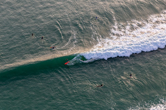 Wave surfers in front of the Plage de Tronoën/Bretagne in Saint-Jean-Trolimon in the state Finistere, France