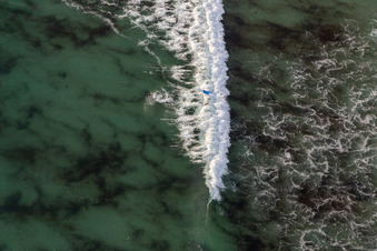 Aerial photograpy of Wave surfers in front of Plage la Torche-Tronoën in Plomeur in the state Finistere, France