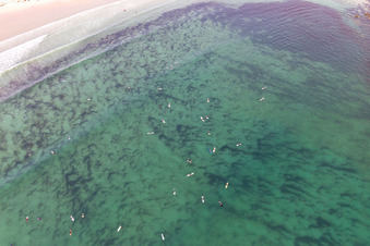 Aerial photograpy of Surfers waiting for the wave in front of the Plage la Torche-Tronoën in Plomeur in the state Finistere, France