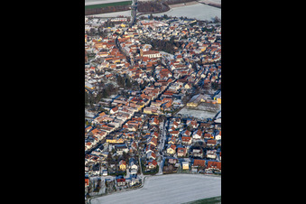 Aerial view of Main street with parish church of St. Michael in winter with snow in Rheinzabern in the state Rhineland-Palatinate, Germany