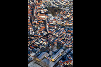 Main street with parish church of St. Michael in winter with snow in Rheinzabern in the state Rhineland-Palatinate, Germany from above