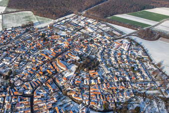 Main street with parish church of St. Michael in winter with snow in Rheinzabern in the state Rhineland-Palatinate, Germany seen from above
