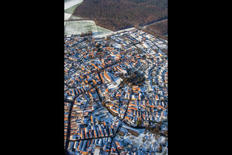 Main street with parish church of St. Michael in winter with snow in Rheinzabern in the state Rhineland-Palatinate, Germany from the plane