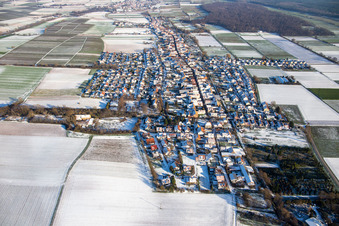 Aerial view of View of the town from the west in winter with snow in Freckenfeld in the state Rhineland-Palatinate, Germany