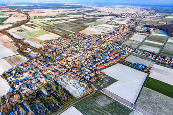 View of the town from the southwest in winter with snow in Freckenfeld in the state Rhineland-Palatinate, Germany