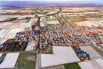 Aerial photograpy of View of the town from the southwest in winter with snow in Freckenfeld in the state Rhineland-Palatinate, Germany