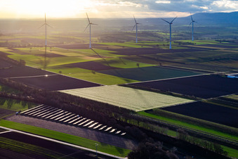 Aerial view of Open-space photovoltaic solar power system of the ANUMAR Solarpark Winden on a field in front of the Freckenfeld wind farm in Winden in the state Rhineland-Palatinate, Germany