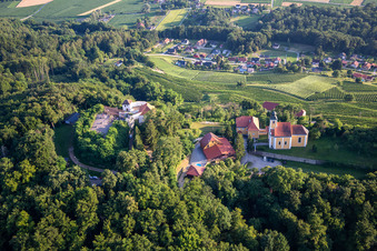 Oblique view of Church of Župnijska cerkev sv. Marije Vnebovzete and Café Huda Liza on the Vurberg in Duplek in the state Slovenia, Slovenia