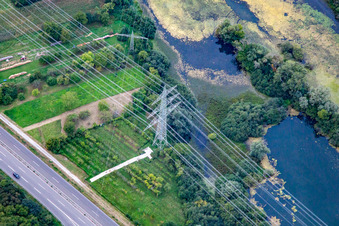 Crossing high-voltage lines in Wörth am Rhein in the state Rhineland-Palatinate, Germany