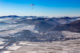 Aerial view of From the east in winter in the snow with paraglider in Klingenmünster in the state Rhineland-Palatinate, Germany