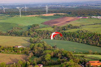 Paramotor in front of wind farm in Herbitzheim in the state Bas-Rhin, France